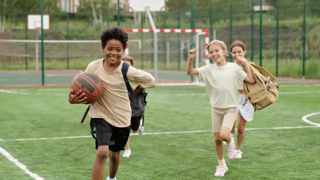 four kids playing on field